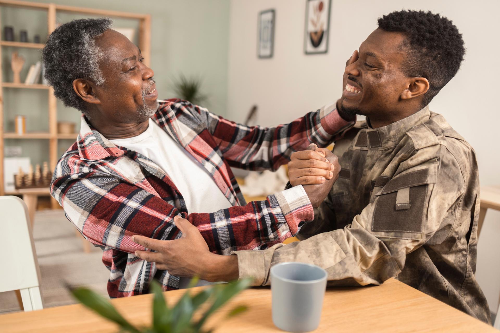 African American soldier meeting with his old father after finally coming back from army