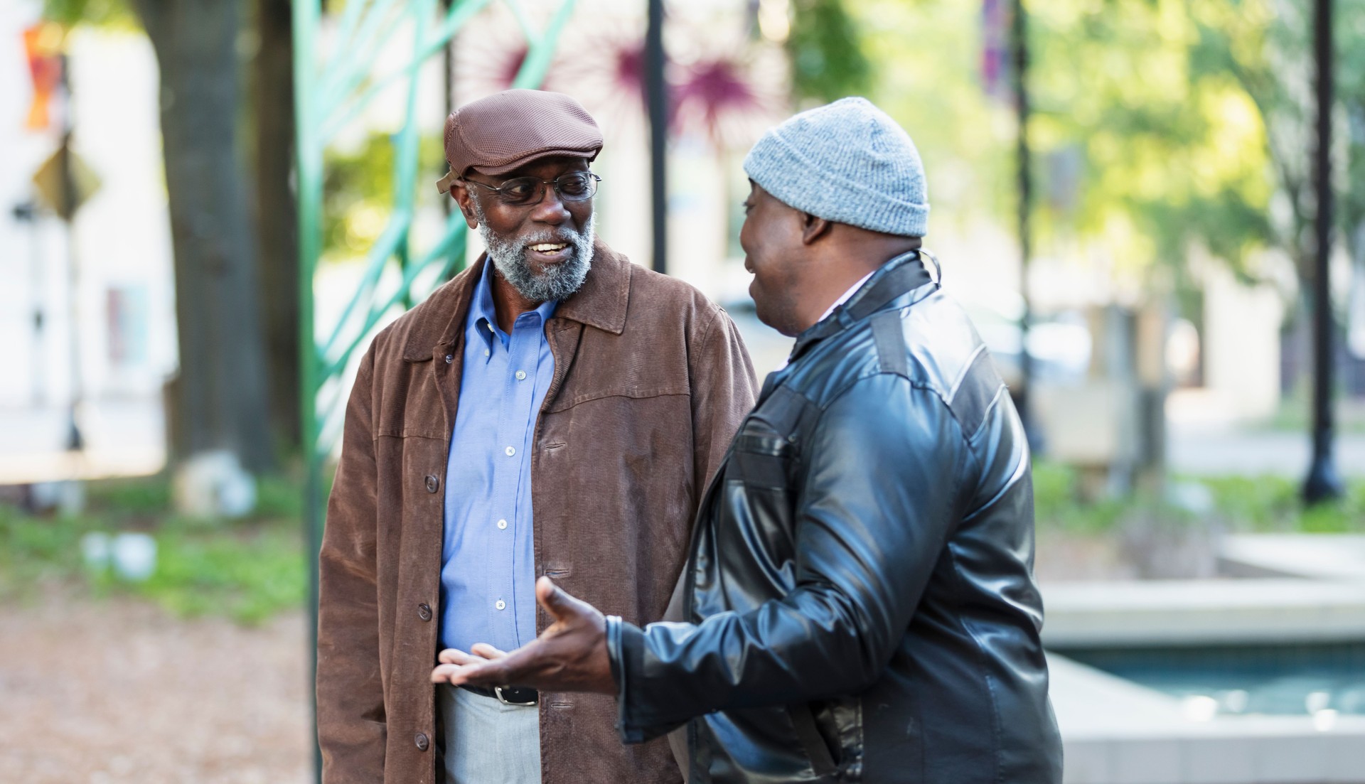 Two senior African-American men talking in city park