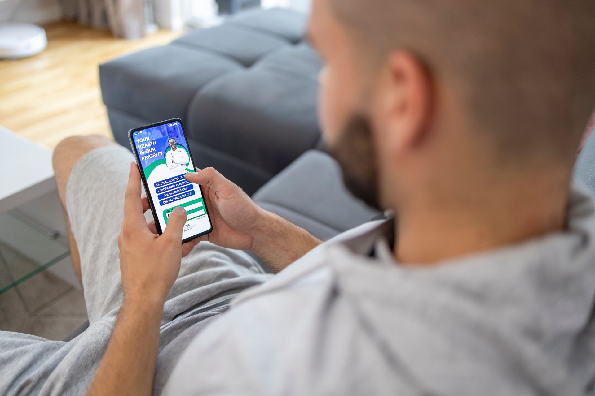 Man holding phone with online medical app on screen