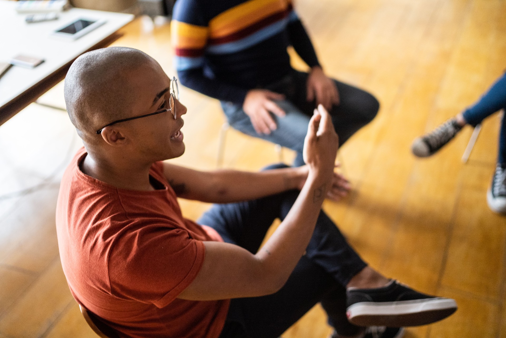 Young man talking in group therapy at a coworking